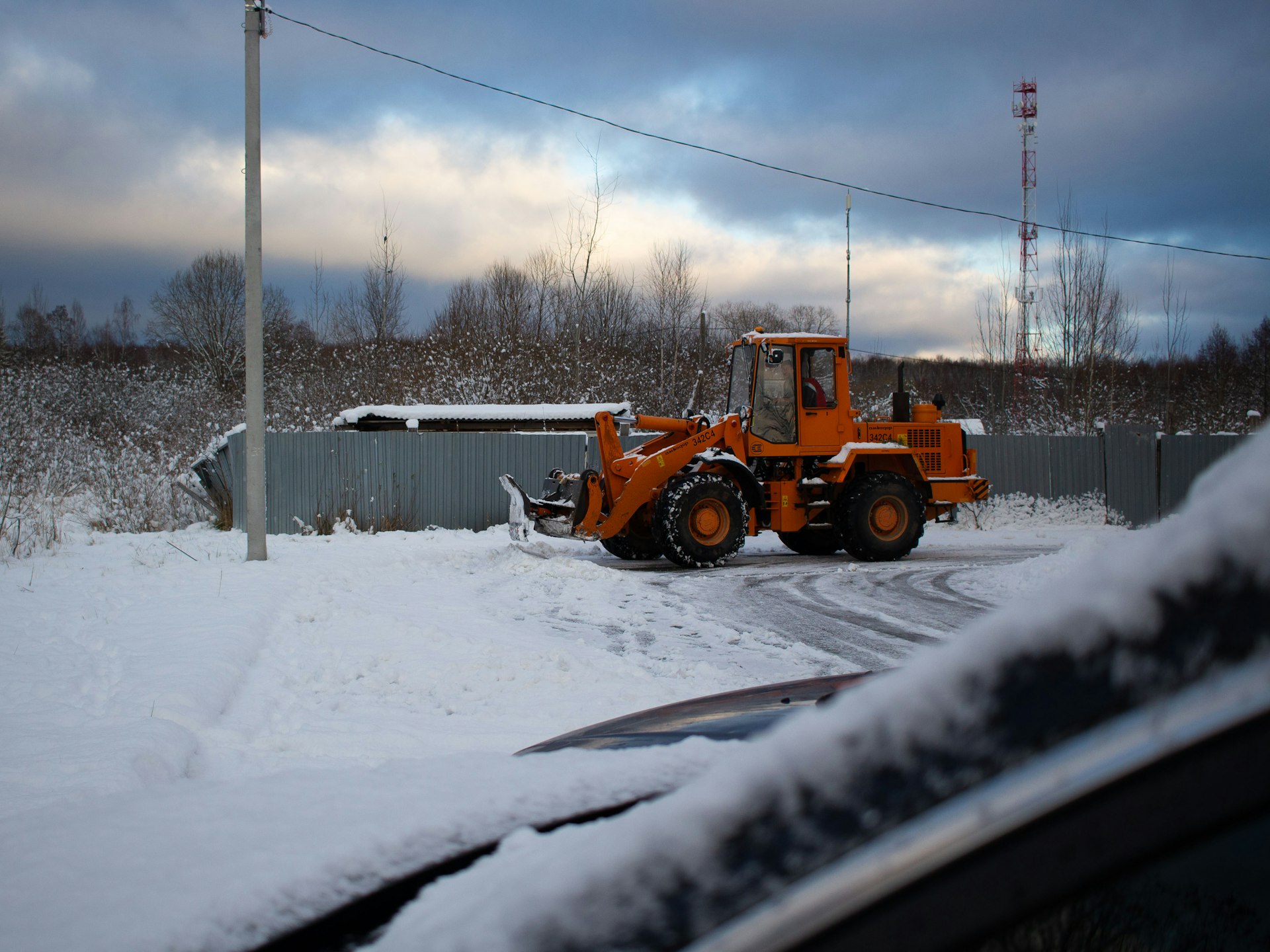 A tractor is parked on a snowy road